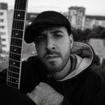 Black and white outdoor portrait of SERVAN, a German Hip-Hop artist, expressing his fearless artistry in the song "21st Century."