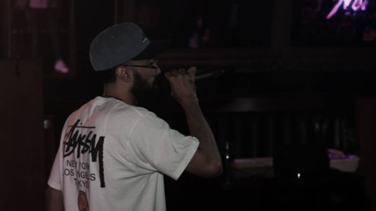 EB the MC performing in Toronto, symbolizing his hit 'Open Letter'