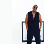 Afrobeats artist Birmingham in a stylish black vest and pants