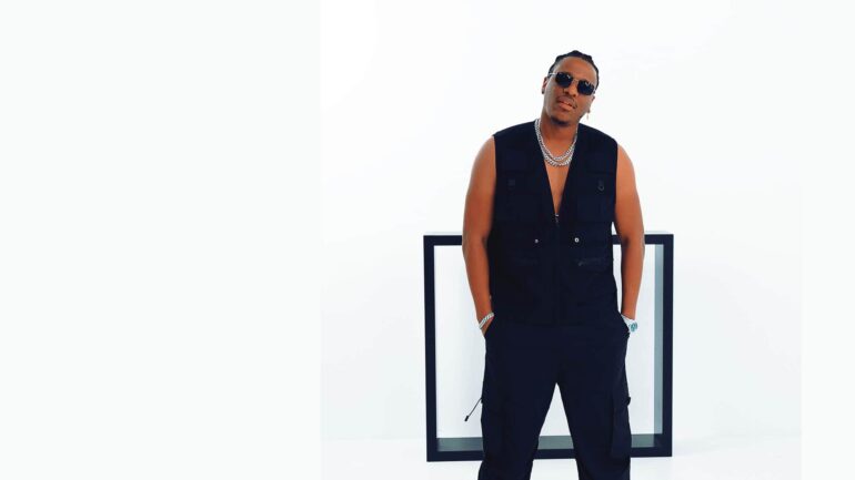 Afrobeats artist Birmingham in a stylish black vest and pants