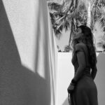 Angie Perera pondering in palm shadows