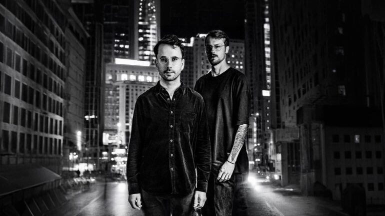 Black and white photo of Thom and the Wolves, two male indie musicians, two with glasses.