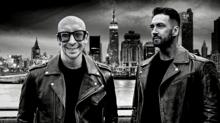 DJ Remo and Robbie Hutton in front of city skyline