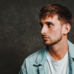 Josh Hearmon sitting on a stool in a casual pose