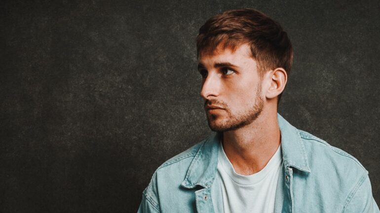 Josh Hearmon sitting on a stool in a casual pose