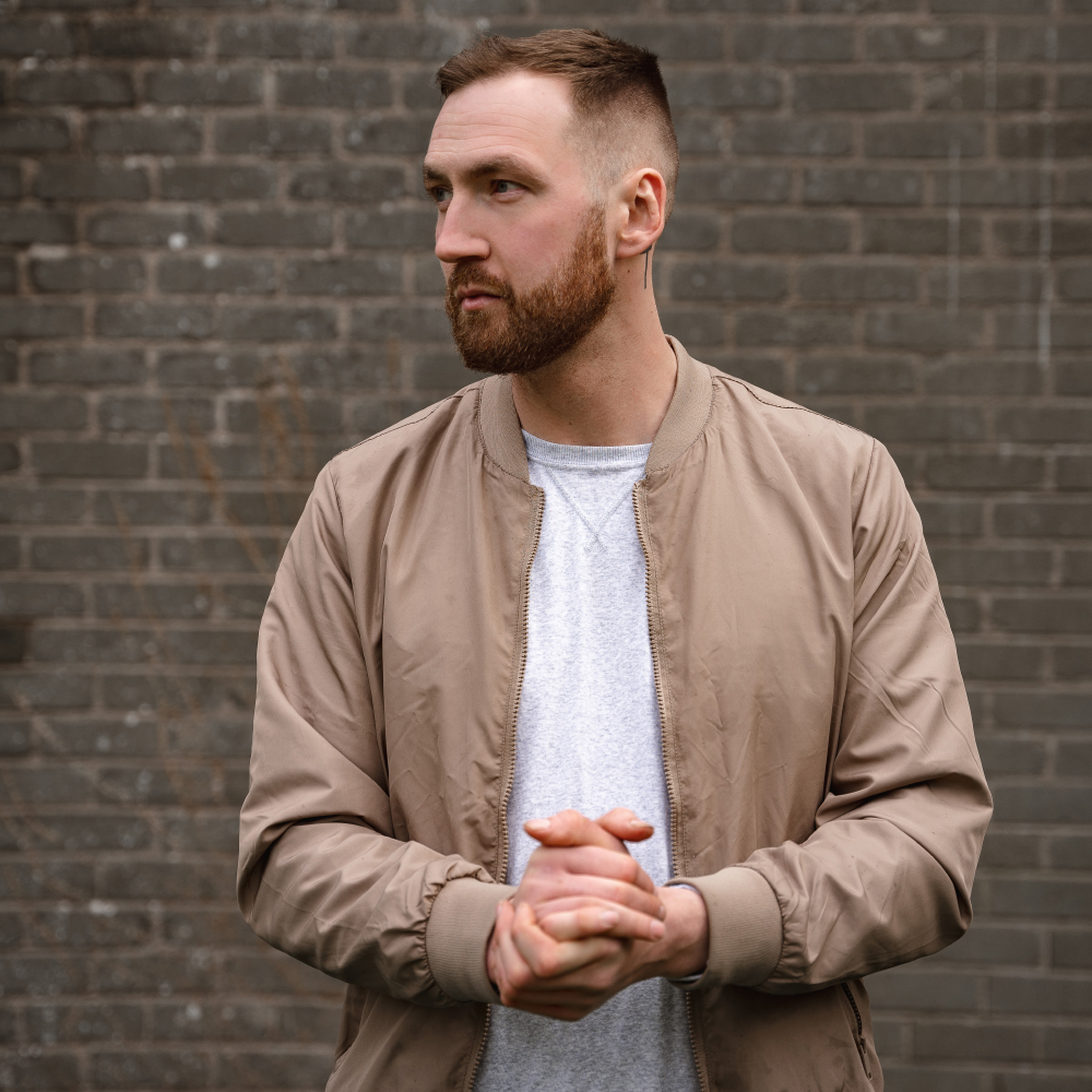 Robbie Hutton posing against a brick wall