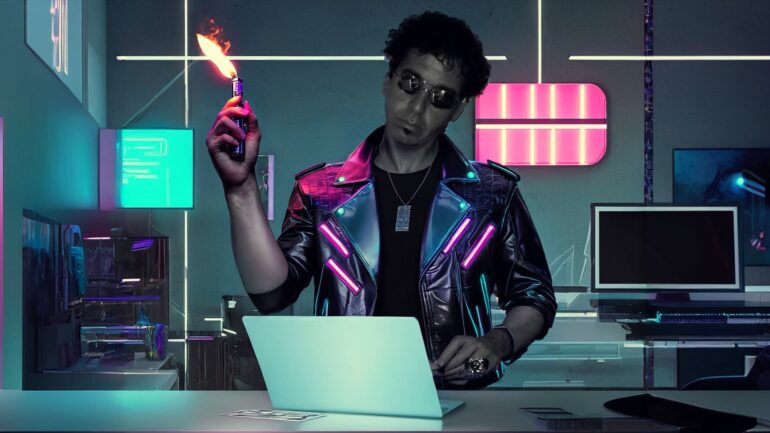 Mike Costanzo, also known as Electro Dream Magma, in a futuristic studio setting, wearing a neon-lit leather jacket and holding a flame torch.