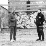 Bogart. (Marin and Jayztylez) stand in front of graffiti-covered walls, highlighting their collaboration on the new hip hop track "Dark Star Demoralizer."