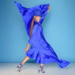 Rhona Bennett dances in a flowing blue dress, expressing joy and emotion.