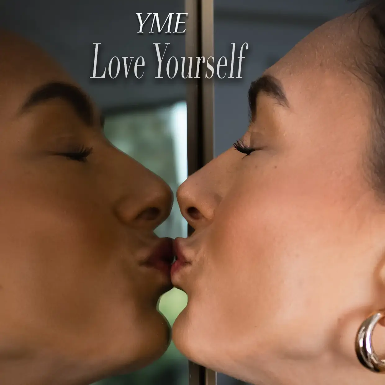 Album cover of YME’s "Love Yourself" showing her kissing her reflection in a mirror, symbolizing self-love.