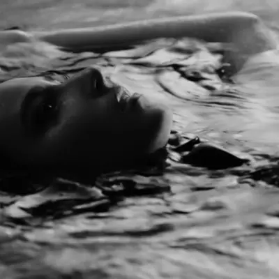 Black-and-white album cover featuring Bruklin submerged in water with a reflective and emotional expression.